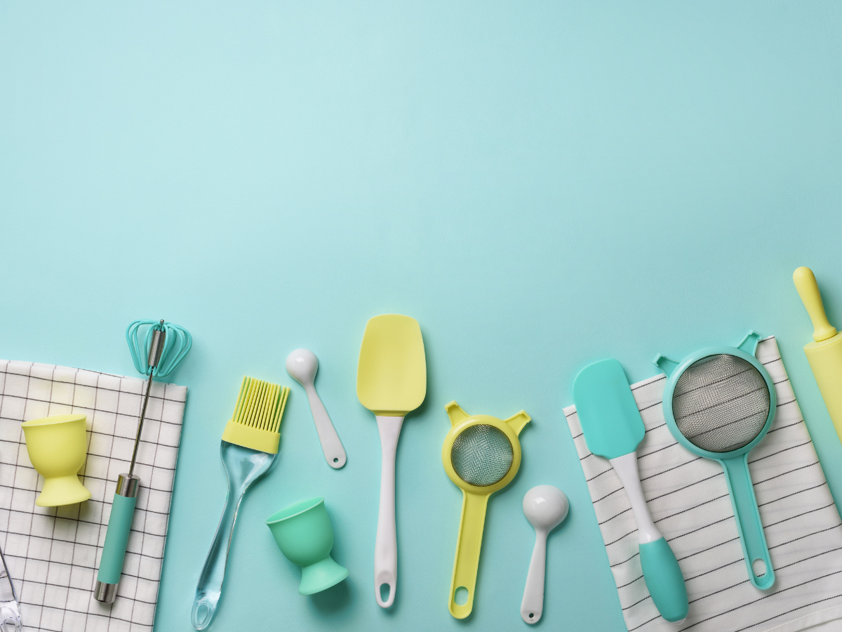 Assorted kitchen utensils on a blue background