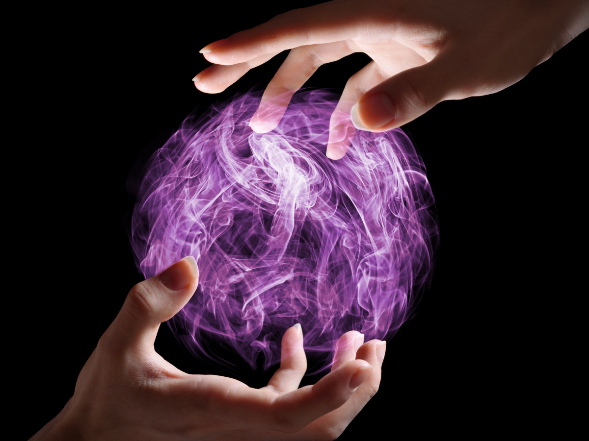 Two hands holding an orb