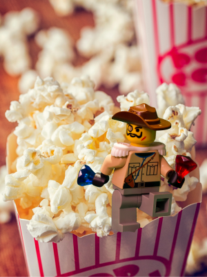 Lego explorer perched on a bucket of popcorn
