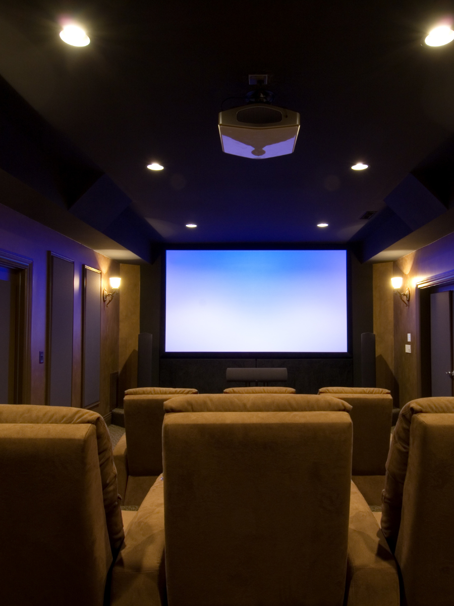 at-home theater set up with chairs, screen, and ceiling-mounted projector