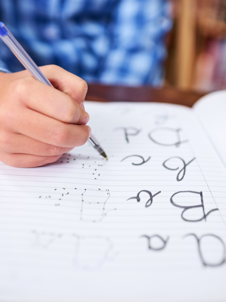 Child writing on lined paper