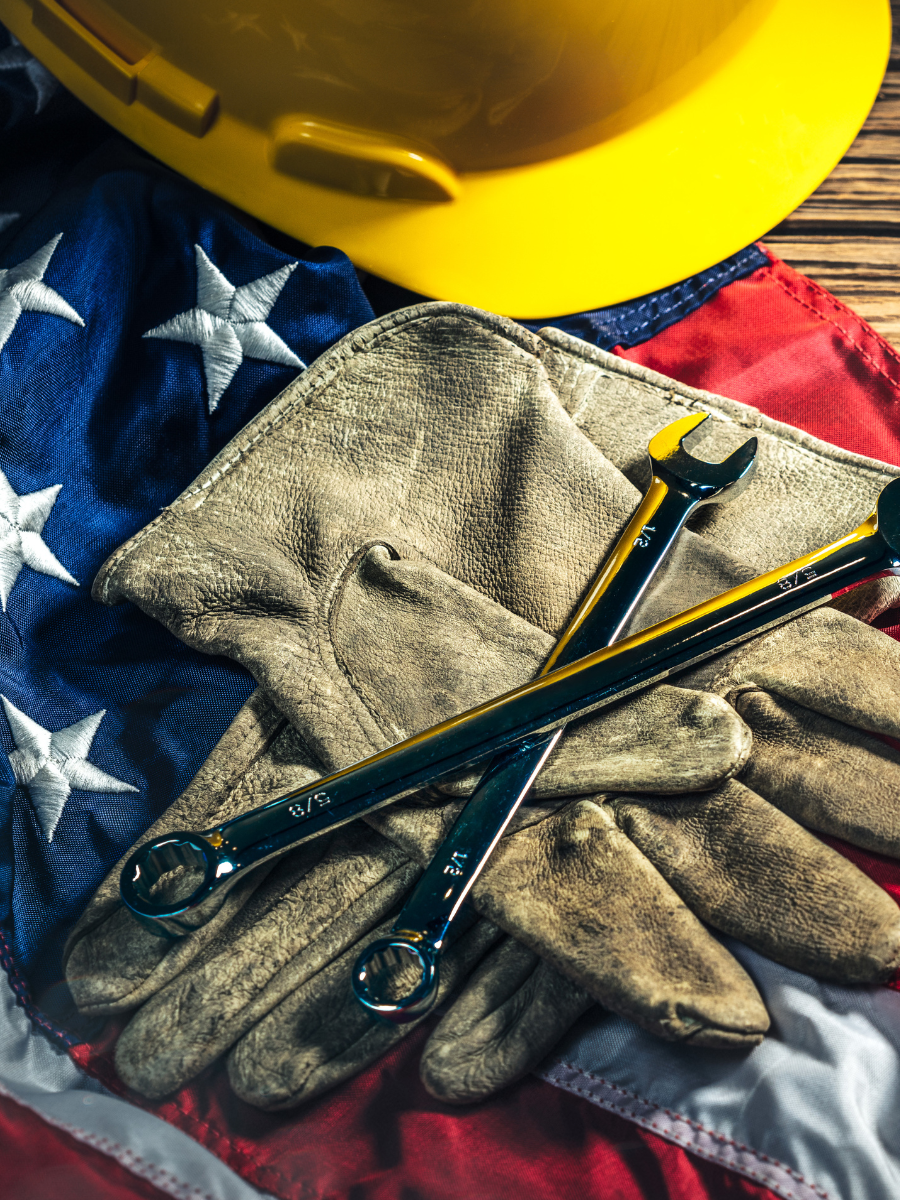 hard hat and work gloves resting on American flag