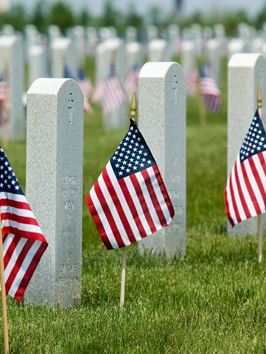 close-up of headstones at Arlington National Cemetery, with flags