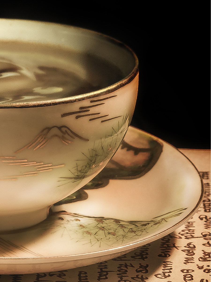 gold rimmed tea cup on saucer