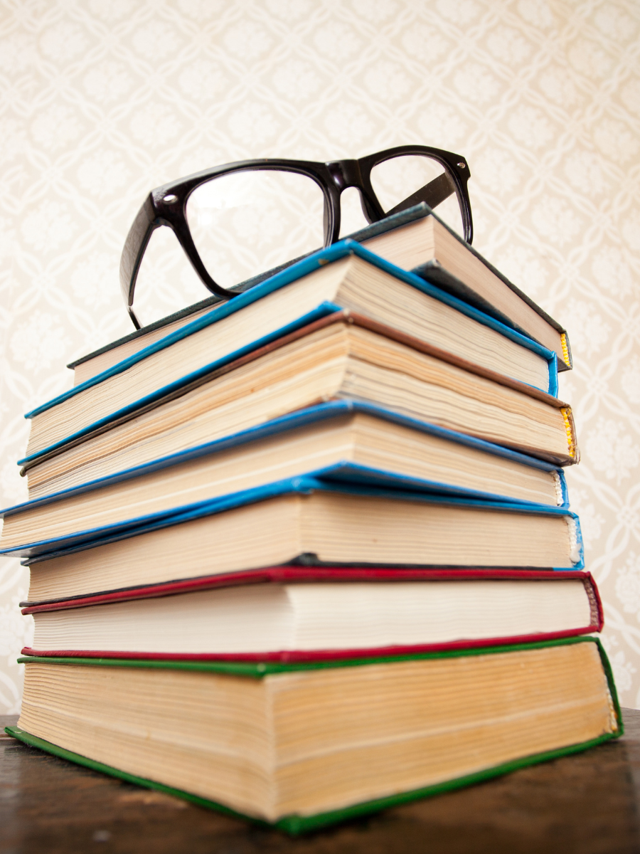 Stack of books with glasses