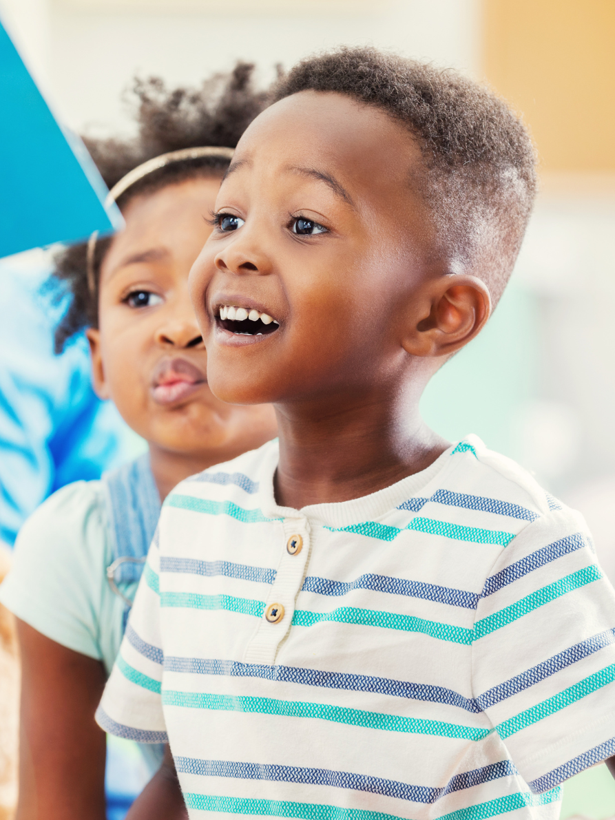 Child excitedly listens to a book being read aloud.