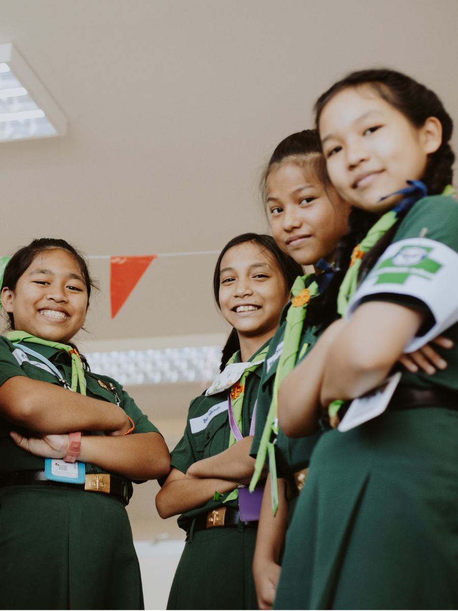 four Girl Scouts smiling at camera