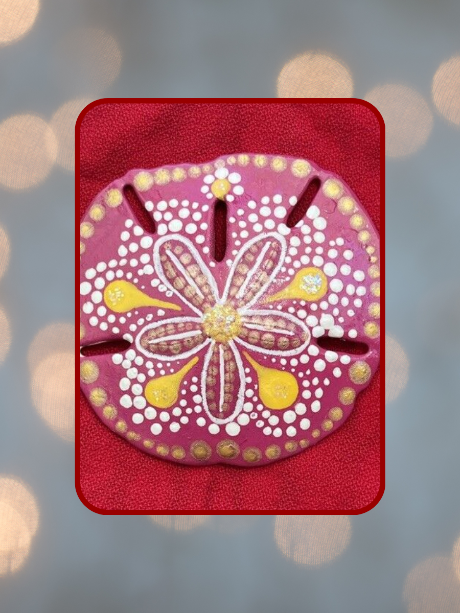 twinkling background with painted sand dollar in foreground