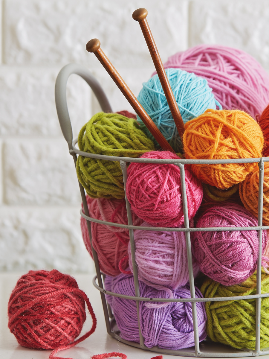 knitting basket with colorful balls of yarn