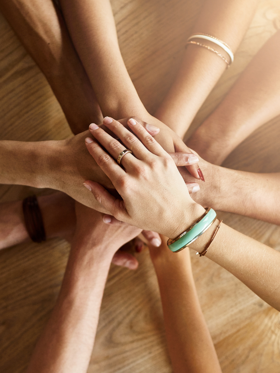 women's hands in stack