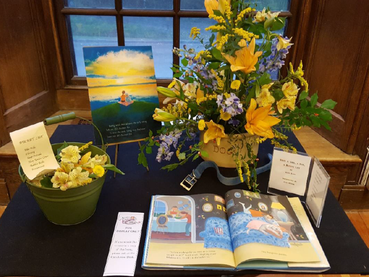 A book and floral arrangement pair