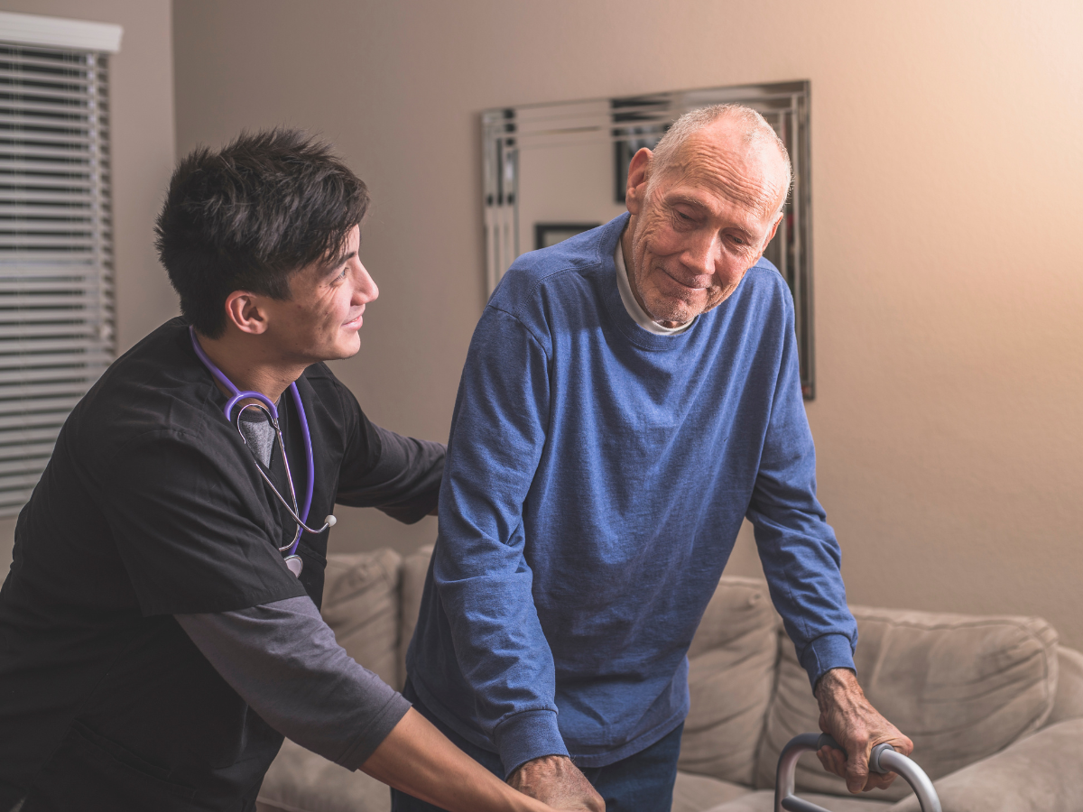 A young man assisting an older gentleman