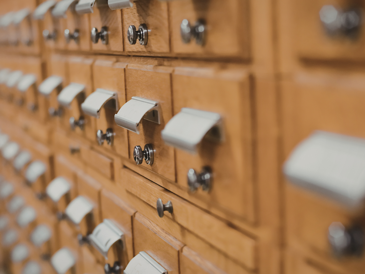 Close up view of wooden library card catalog drawers
